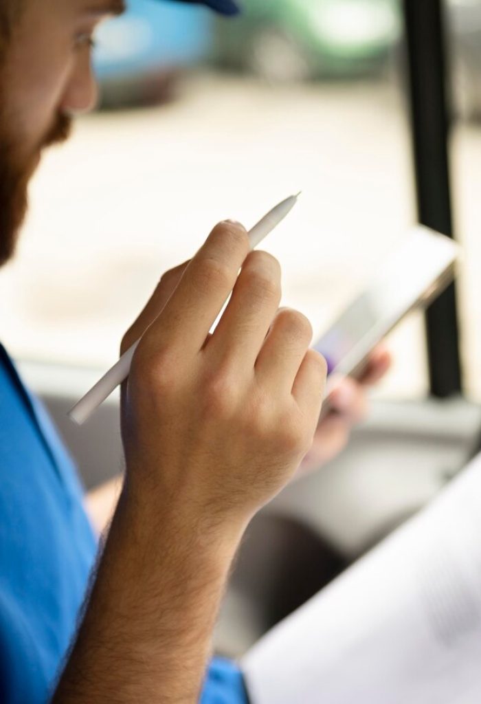close-up-delivery-man-with-document_23-2149035888